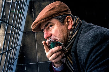 man wearing cadet cap neat window thumbnail