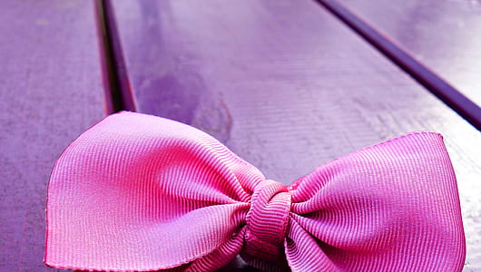 pink ribbon on purple wooden surface thumbnail