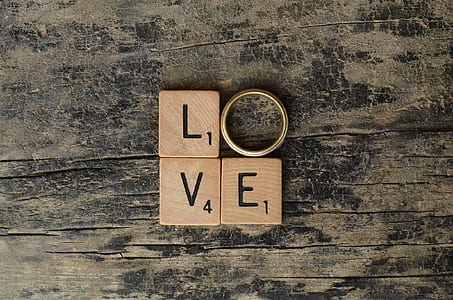 brown LVE scrabble letters beside gold-colored ring thumbnail