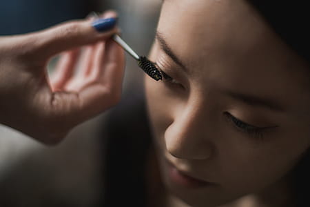 Woman Getting Mascara Makeup Photo thumbnail