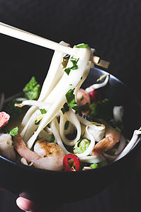 brown chopstick over ramen on black ceramic bowl thumbnail