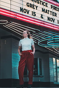 woman inserting her both hands inside red pants thumbnail