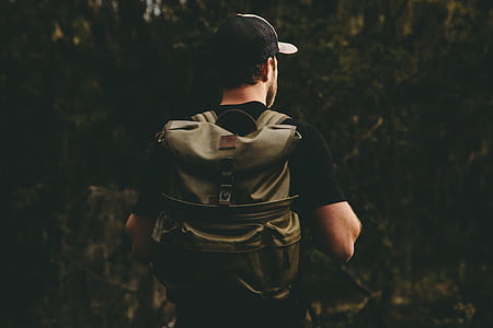 man wears black shirt and brown leather backpack thumbnail