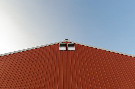 orange and white painted barn over blue and cloudy sky at daytime thumbnail