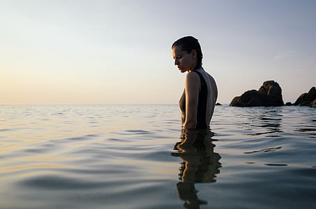 woman in swimsuit on body of water thumbnail