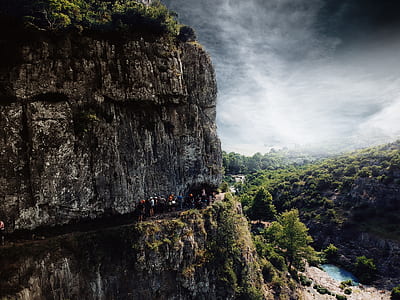 people walking on mountain edge thumbnail