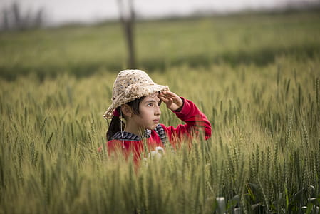 Girl in Red Hoodie Wearing Beige Sunhat thumbnail