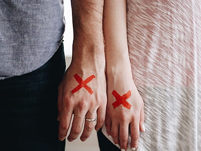 man and woman wrote X mark on their hands thumbnail