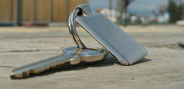 silver key on cement floor thumbnail