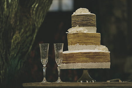 3-tier cake beside two wine glasses thumbnail