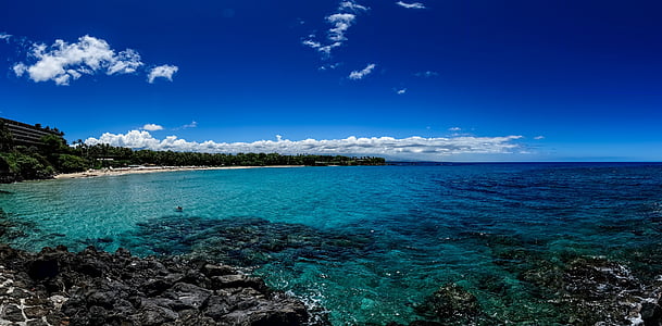 seashore under white clouds and blue sky during daytime thumbnail