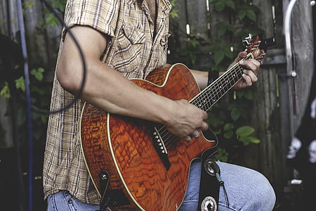 man in brown, black, and white plaid button-up t-shirt using brown acoustic guitar thumbnail