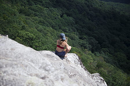 woman sitting near edge of cliff thumbnail