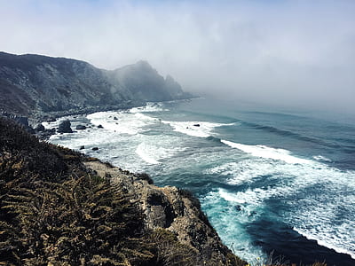 aerial view of seashore under dark clouds thumbnail