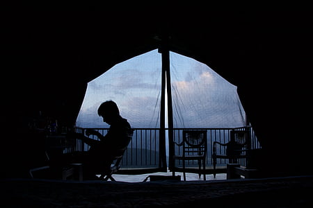 silhouette of man sitting on chair thumbnail