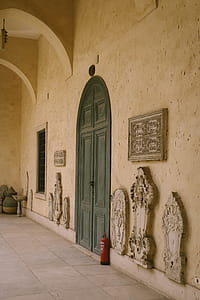 Grey Wooden Door Between Beige Concrete Wall thumbnail