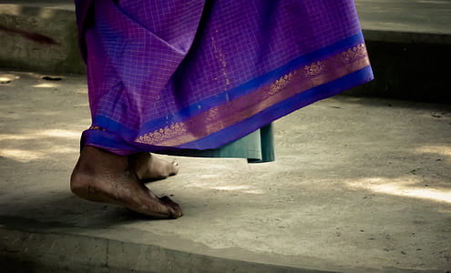 selective focus of person walking in barefoot during daytime thumbnail
