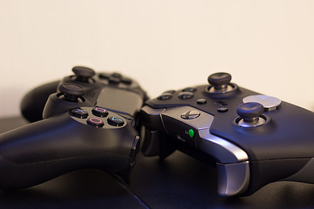 closeup photo of Xbox and Sony controllers thumbnail