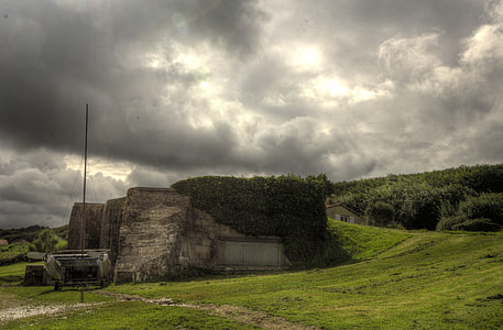 gray concrete building under clouded sky thumbnail