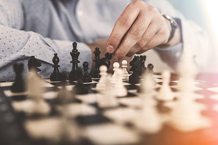 Young businessman playing chess in the office thumbnail