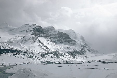 snow-covered mountain under white clouds thumbnail