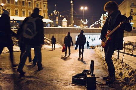 man playing electric guitar on side of road thumbnail