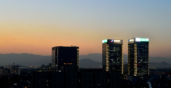 golden-hour photography of glass high rise buildings at the city thumbnail