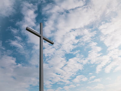 gray cross under blue and white sky thumbnail