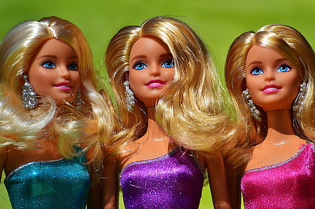 close-up photography of three barbie doll wearing dress thumbnail