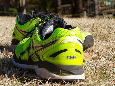 closeup of green ACIS sneakers on beige grass thumbnail