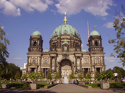 brown and teal concrete cathedral under blue sky during daytime thumbnail