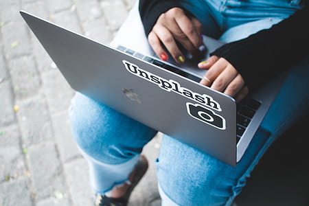 person using silver MacBook on lap thumbnail