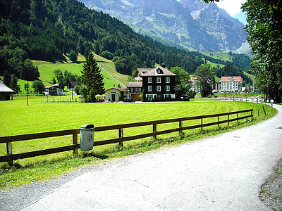 brown and black concrete house near mountain at daytime thumbnail