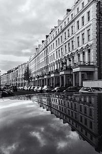 grayscale photo of concrete building near river thumbnail