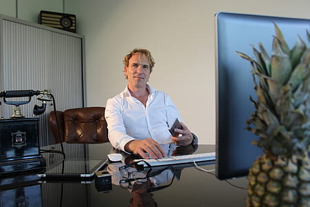 man sitting and working on his desk with computer thumbnail