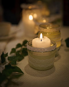 white votive candle on clear glass holder thumbnail
