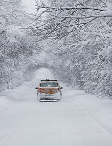 red vehicle on snowy road thumbnail