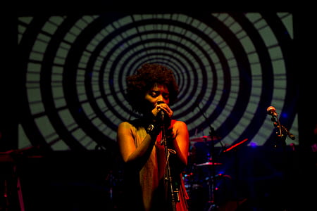 woman using microphone while singing thumbnail