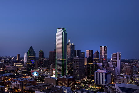 high-rise buildings under blue and gray sky at nighttime thumbnail