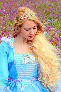 shallow focus of woman wearing blue dress and crown thumbnail