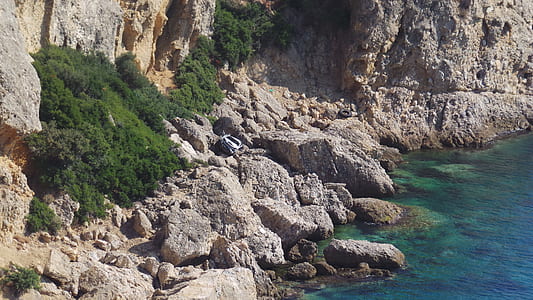 white vehicle on rock formation thumbnail