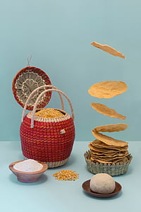 wicker round red and gray basket on teal surface beside round brown bowl thumbnail