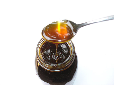clear glass bottle filled with honey thumbnail