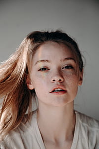 woman in white shirt taking selfie thumbnail