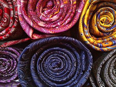 roll of assorted-color-and-pattern textiles thumbnail