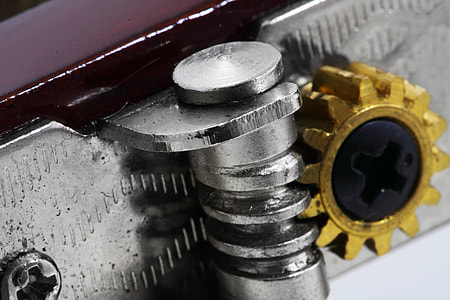 gray metal threaded tool with gold gear thumbnail