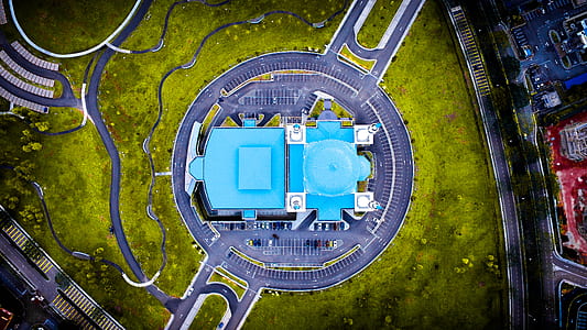 aerial photography of blue building near green grass thumbnail