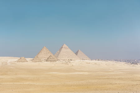 photo of three pyramids on desert under blue sky during daytime thumbnail