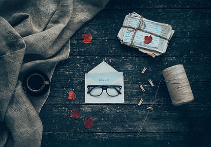 black framed eyeglasses on white printer paper thumbnail