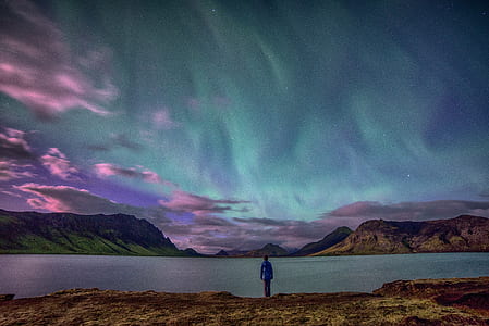 person standing in front of lake watching Aurora event thumbnail